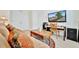 Comfortable living room featuring a sofa, a desk area, a television, and a stylish rug at 5624 Palmer Cir # 101, Bradenton, FL 34211