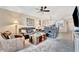 A well lit living room with leather furniture and an open view into the dining area at 5624 Palmer Cir # 101, Bradenton, FL 34211