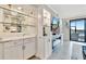 Living room with glass shelving, a tv, and a sliding glass door at 5624 Palmer Cir # 101, Bradenton, FL 34211