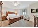 The main bedroom features a large bed, ceiling fan and a view of the water at 5624 Palmer Cir # 101, Bradenton, FL 34211