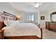 The large main bedroom features a window with lots of natural light, a ceiling fan and crown molding at 5624 Palmer Cir # 101, Bradenton, FL 34211