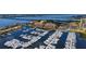 Wide aerial view of waterfront complex, marina, and lush landscapes at 606 Riviera Dunes Way # 306, Palmetto, FL 34221