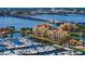 Stunning aerial shot of waterfront buildings, marina, and lush surroundings at 606 Riviera Dunes Way # 306, Palmetto, FL 34221
