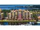 Scenic aerial view of a waterfront building with a marina and lush landscaping at 606 Riviera Dunes Way # 306, Palmetto, FL 34221