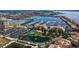 Beautiful aerial shot of a condo community with a marina, pond, tennis court, and lush landscaping at 606 Riviera Dunes Way # 306, Palmetto, FL 34221