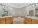 Double vanity bathroom showcasing a soaking tub, vanity, and recessed lighting at 606 Riviera Dunes Way # 306, Palmetto, FL 34221