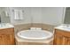 Luxurious bathroom features a soaking tub, double vanities, and tiled surround at 606 Riviera Dunes Way # 306, Palmetto, FL 34221