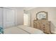 Bedroom with dresser and mirror, showcasing ample storage space at 606 Riviera Dunes Way # 306, Palmetto, FL 34221