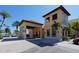 Exterior view of a Mediterranean-style building with a tile roof, arched entrance, and palm trees at 606 Riviera Dunes Way # 306, Palmetto, FL 34221
