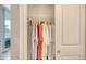 Bright closet view showing rods for hanging clothes and a door that leads to a lanai at 606 Riviera Dunes Way # 306, Palmetto, FL 34221