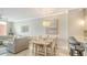 Comfortable dining area with seating for six open to the living room and kitchen at 606 Riviera Dunes Way # 306, Palmetto, FL 34221