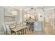 Inviting dining area featuring a wood table, seating for six, and modern lighting at 606 Riviera Dunes Way # 306, Palmetto, FL 34221