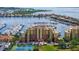Attractive condo building with harbor view, featuring manicured landscaping and tennis courts at 606 Riviera Dunes Way # 306, Palmetto, FL 34221