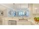 Open concept kitchen featuring a breakfast bar with marble countertops at 606 Riviera Dunes Way # 306, Palmetto, FL 34221