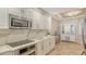 Modern kitchen with stainless steel appliances, white cabinetry, and stylish finishes at 606 Riviera Dunes Way # 306, Palmetto, FL 34221