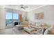 Comfortable living room featuring white sofa, modern decor, and access to a private balcony at 606 Riviera Dunes Way # 306, Palmetto, FL 34221
