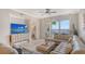 Bright living room featuring a large sectional sofa and sliding glass doors to the balcony at 606 Riviera Dunes Way # 306, Palmetto, FL 34221