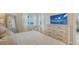 Spacious main bedroom with a large dresser and TV, offering a relaxing retreat at 606 Riviera Dunes Way # 306, Palmetto, FL 34221