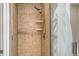 Shower with tiled surround and glass door with beach decor at 606 Riviera Dunes Way # 306, Palmetto, FL 34221