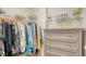 Well-organized walk-in closet with ample hanging space, shelving, and a storage cabinet at 606 Riviera Dunes Way # 306, Palmetto, FL 34221