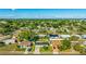 Aerial view of a charming single-story home with a well-maintained lawn and mature trees in a peaceful neighborhood at 6423 Georgia Ave, Bradenton, FL 34207