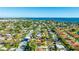 Wide aerial shot showcasing the home's location with beautiful water views nearby and lush landscaping throughout the neighborhood at 6423 Georgia Ave, Bradenton, FL 34207