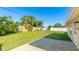 Large backyard with a well-maintained lawn, a storage shed, palm trees and partial patio, perfect for outdoor activities at 6423 Georgia Ave, Bradenton, FL 34207