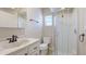 Compact bathroom featuring a glass-enclosed shower and vanity sink at 6423 Georgia Ave, Bradenton, FL 34207