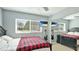 Bright bedroom with a bed, closet, and a mounted TV, creating a comfortable and modern space at 6423 Georgia Ave, Bradenton, FL 34207