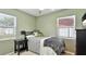 Serene bedroom featuring a bed with decorative pillows, a side table and natural light at 6423 Georgia Ave, Bradenton, FL 34207