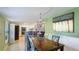 Open concept dining room, showcasing the adjacent kitchen and natural light at 6423 Georgia Ave, Bradenton, FL 34207