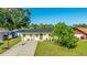 A well-maintained single-story home featuring a well-maintained lawn, tidy landscaping, and new roof at 6423 Georgia Ave, Bradenton, FL 34207