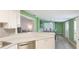 Kitchen featuring modern countertops, a breakfast bar, and views into the open concept dining and living spaces at 6423 Georgia Ave, Bradenton, FL 34207