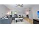 An open living room with a comfortable gray sofa, stylish coffee table, and modern ceiling fan at 6423 Georgia Ave, Bradenton, FL 34207