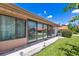 View of the home's backyard, featuring large sliding glass doors at 6462 Draw Ln # 72, Sarasota, FL 34238