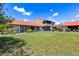 Home featuring a backyard with green grass and manicured landscaping at 6462 Draw Ln # 72, Sarasota, FL 34238