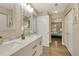 Bathroom featuring a marble countertop, double sink, and view to bedroom at 6462 Draw Ln # 72, Sarasota, FL 34238
