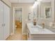 Bathroom featuring a marble countertop, double sink, and a separate toilet room at 6462 Draw Ln # 72, Sarasota, FL 34238