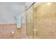 Bathroom featuring a glass-door shower with patterned ceramic tiles and built-in seat at 6462 Draw Ln # 72, Sarasota, FL 34238