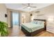 Comfortable bedroom featuring a walk-in closet, wood floors, and a ceiling fan at 6462 Draw Ln # 72, Sarasota, FL 34238