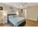 Comfortable bedroom featuring a ceiling fan, wood floors, and a decorative shelf at 6462 Draw Ln # 72, Sarasota, FL 34238
