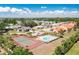 Aerial view of a community pool, tennis court, and other neighborhood amenities at 6462 Draw Ln # 72, Sarasota, FL 34238