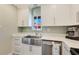 This modern kitchen features a stainless steel farmhouse sink and beautiful backsplash at 6462 Draw Ln # 72, Sarasota, FL 34238