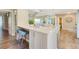 Kitchen with a white quartz countertop, stylish barstools, and views of the living area at 6462 Draw Ln # 72, Sarasota, FL 34238