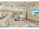 Open-concept living room with a large sectional sofa and view to the dining area at 6462 Draw Ln # 72, Sarasota, FL 34238