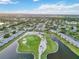 Beautiful aerial view of a community with a large pond and an immaculate golf course and manicured lawns at 6999 W Country Club N Dr # 224, Sarasota, FL 34243