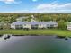 An aerial shot showcasing the condo buildings and adjacent scenic pond at 6999 W Country Club N Dr # 224, Sarasota, FL 34243
