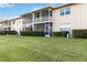 Well maintained backyard with green grass and view of the building and lanais at 6999 W Country Club N Dr # 224, Sarasota, FL 34243