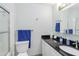 Well-lit bathroom featuring a toilet, sink, vanity, and shower with glass door at 6999 W Country Club N Dr # 224, Sarasota, FL 34243