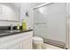 Modern bathroom with white vanity, granite countertop, sleek fixtures, and a glass-enclosed shower at 6999 W Country Club N Dr # 224, Sarasota, FL 34243